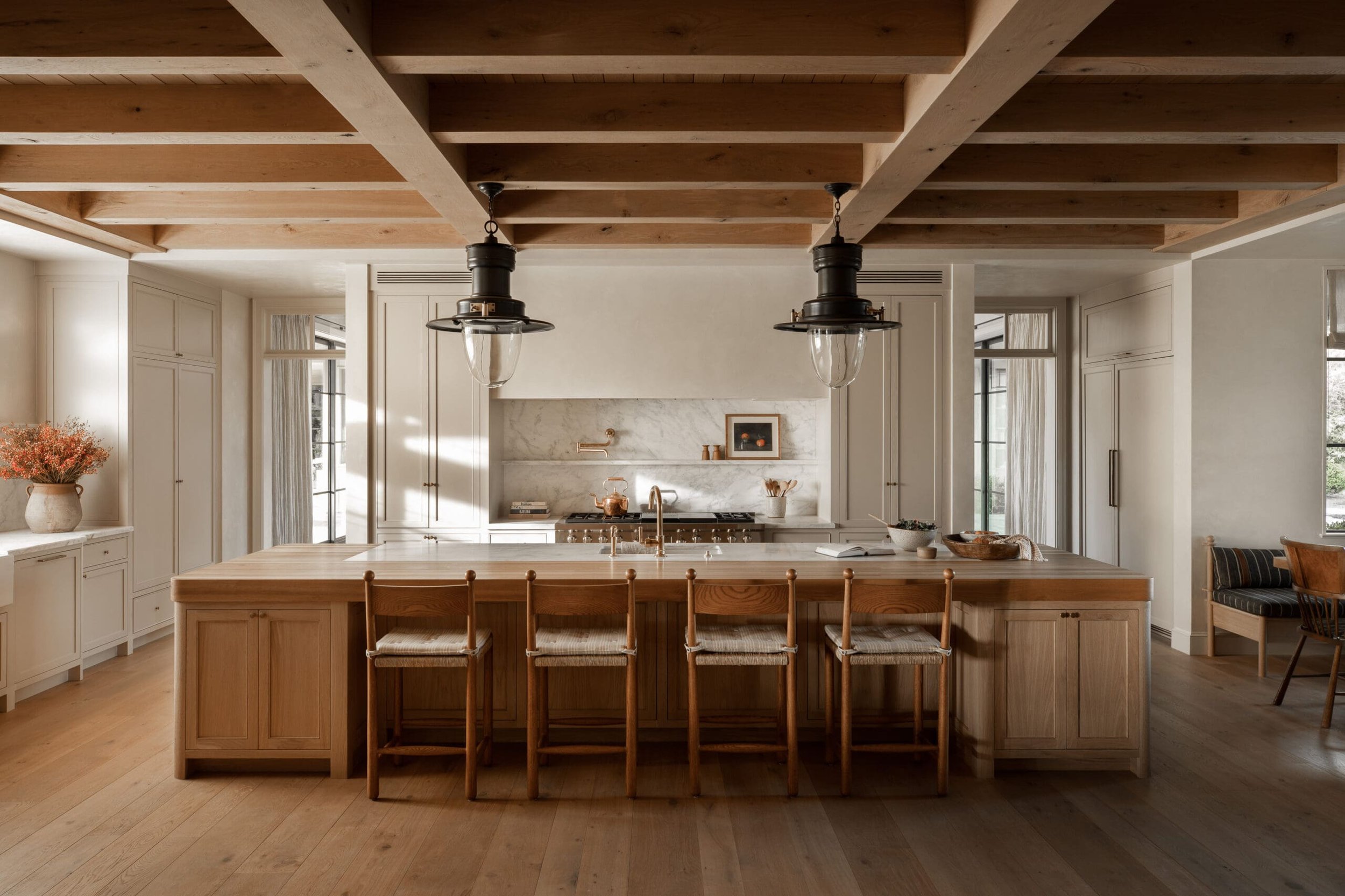 719 Amalfi: timber-beamed kitchen with an oak island and marble backsplash.